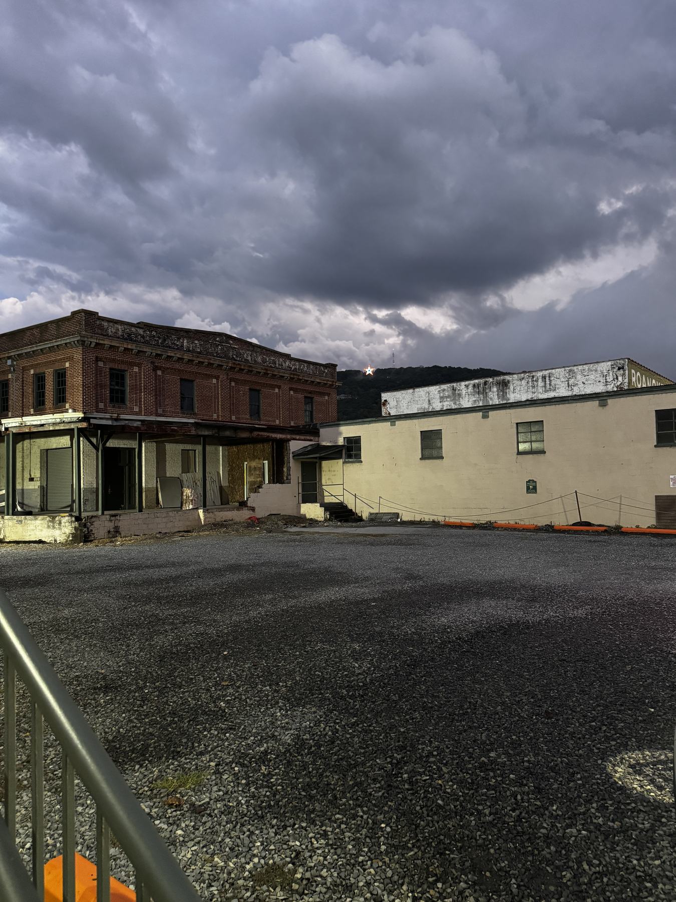 The long brick elevation of the Can Company Warehouse on Albemarle Avenue, with the Mill Mountain Star on the hillside beyond.
